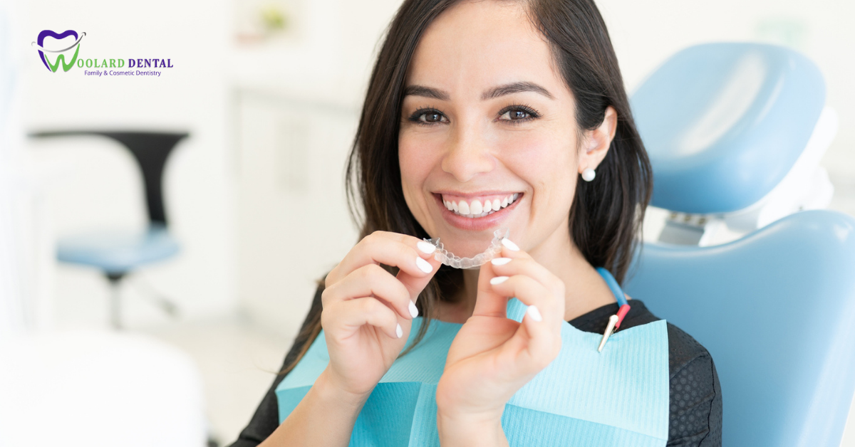 woman with clear invisalign teeth aligner at the dentist braces